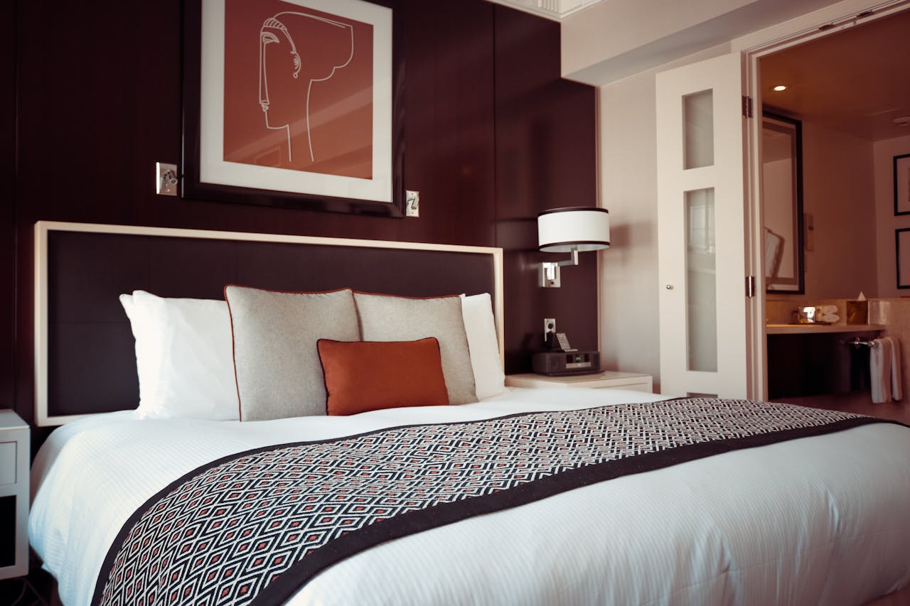 services-03 Cozy and modern hotel bedroom interior with elegant decor and soft lighting.